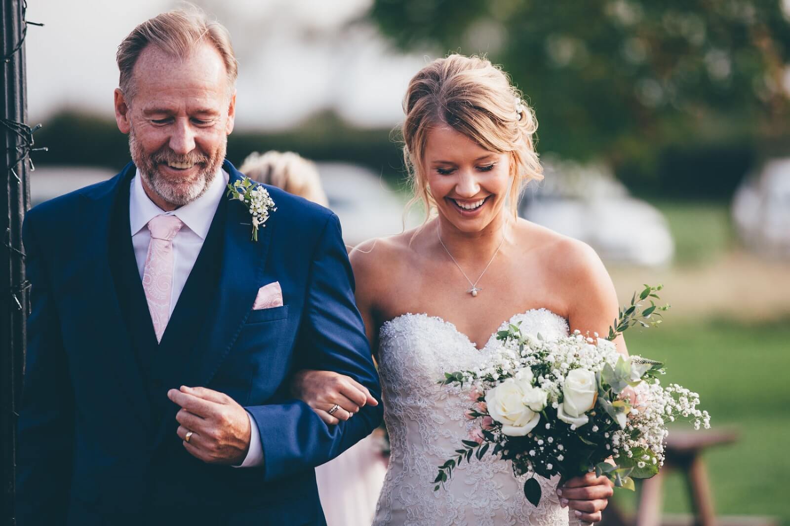 White and green brides bouquet with bride and father at Bridge House Barn